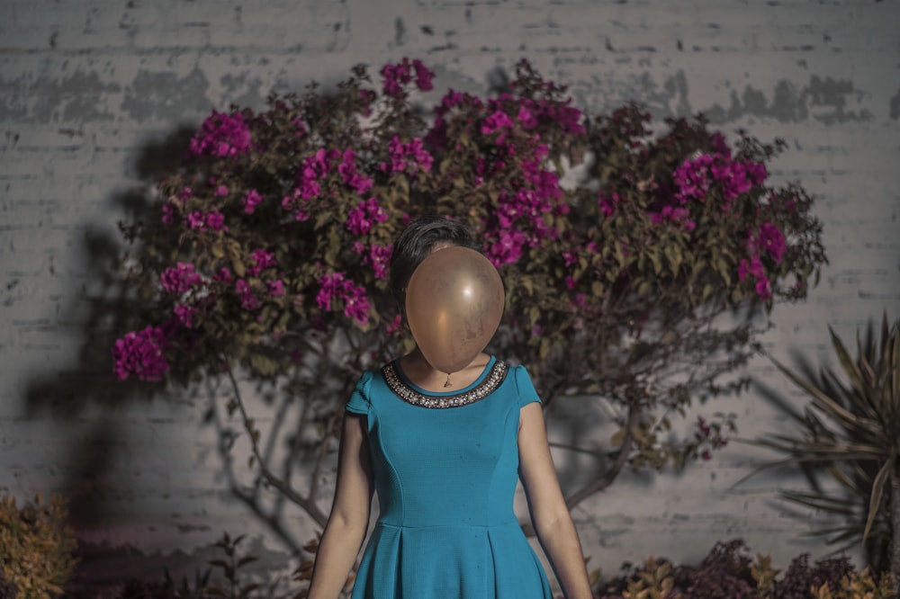 woman standing in front of brown balloon