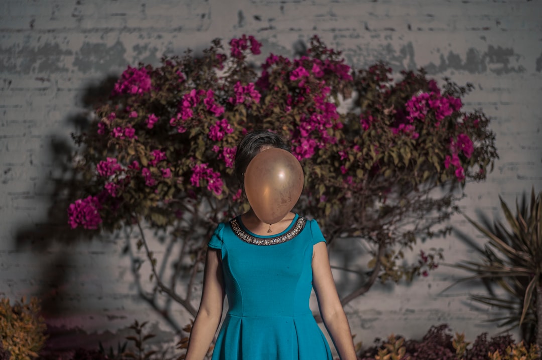 woman standing in front of brown balloon