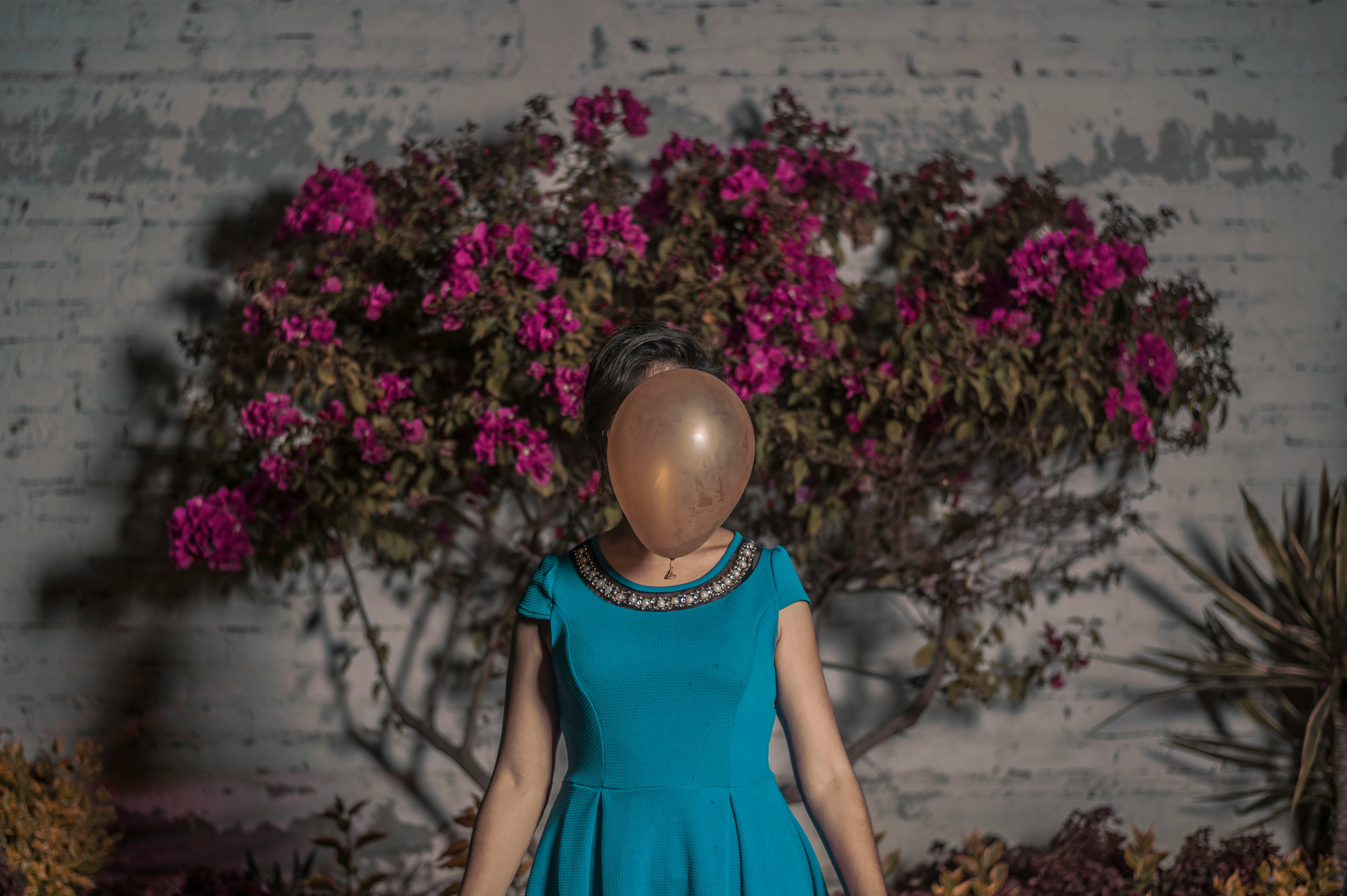 woman standing in front of brown balloon