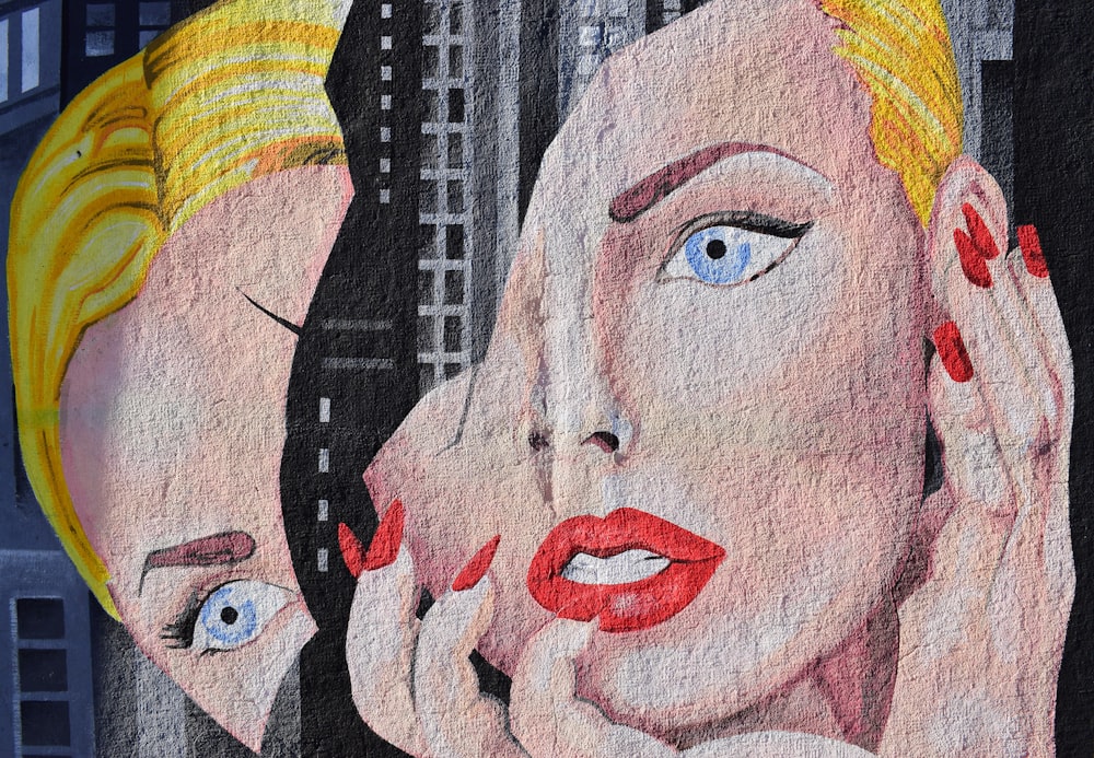 Street art mural of attractive blonde haired woman with red nails and lipstick with shattered face