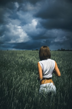 woman in sleeveless top on plants field