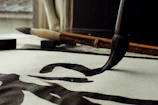 Candid shot of artist's hand creating elegant calligraphy with a brush pen.