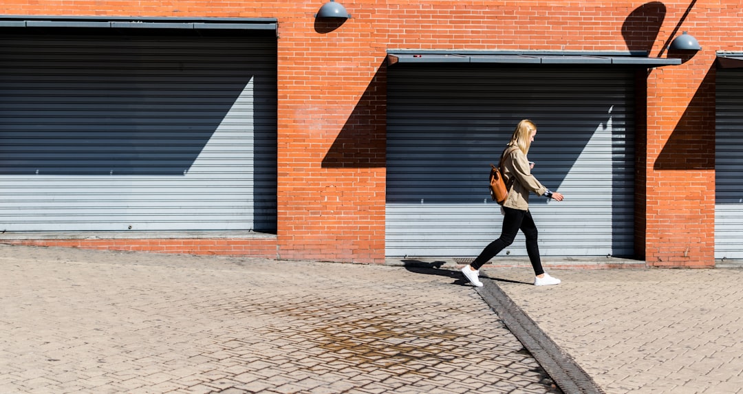 man walking on running bone pavement, Walking between walls