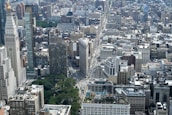 An aerial view of a bustling cityscape showcasing various real estate properties.