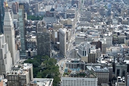 An aerial view of a bustling cityscape showcasing various real estate properties.
