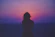 silhouette of a woman with pink and purple sky
