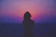 silhouette of a woman with pink and purple sky