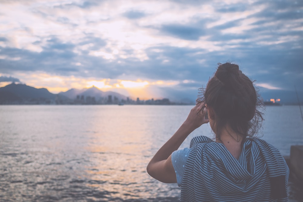 woman standing near body of water during daytime