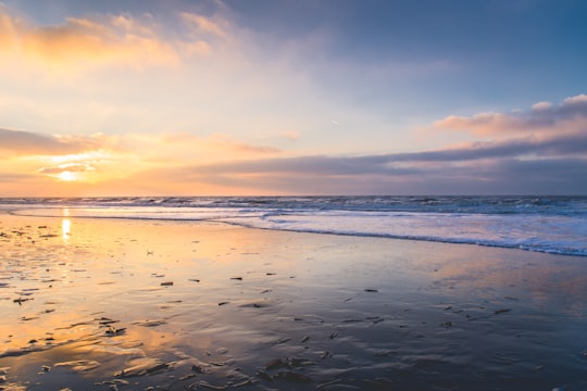 sea waves crashing on shore during sunset in Zandvoort Netherlands