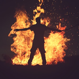 person standing in front of fire during night time