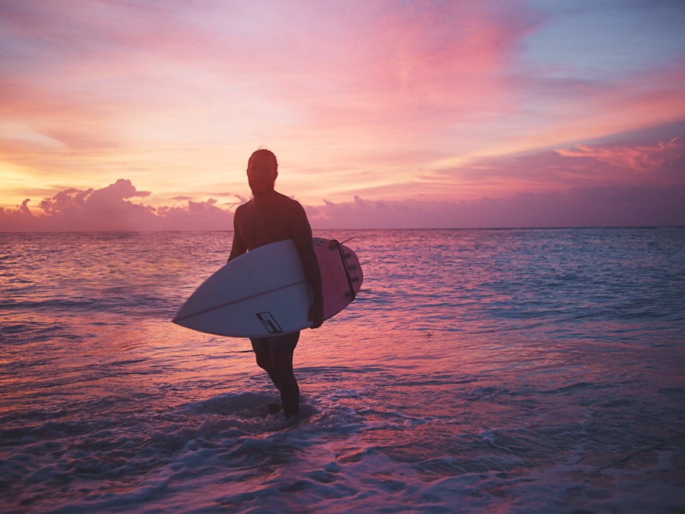 man holding surfboard