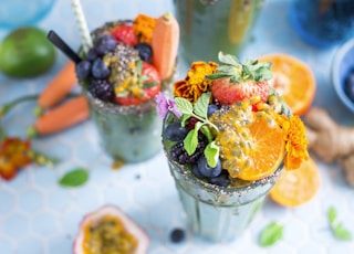 tilt shift lens photography of fruits in drinking glass