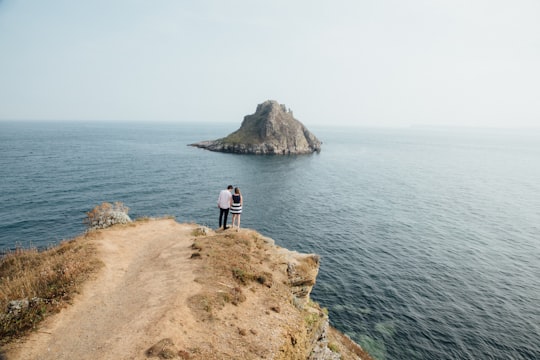 aerial photography of man and woman near cliff in Torquay United Kingdom