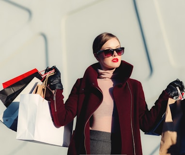 photo of woman holding white and black paper bags