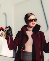 photo of woman holding white and black paper bags