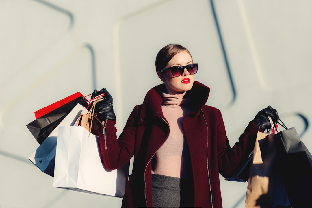 High fashion woman carries a handful of shopping bags