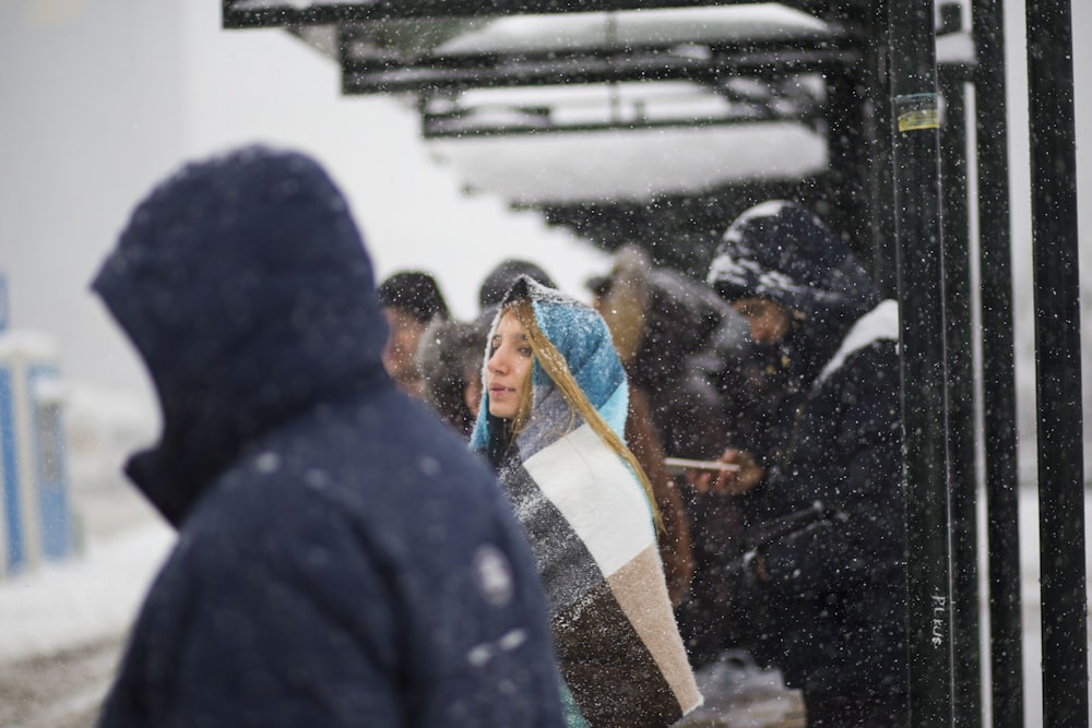 people waiting on shed during snowy season