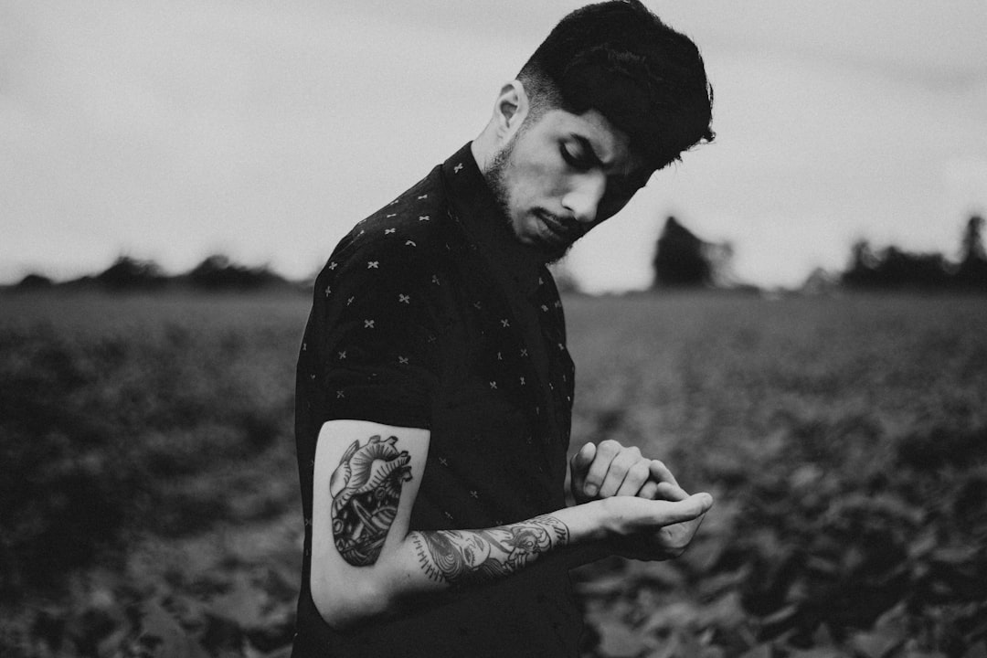 man black heart tattoo on left arm,
