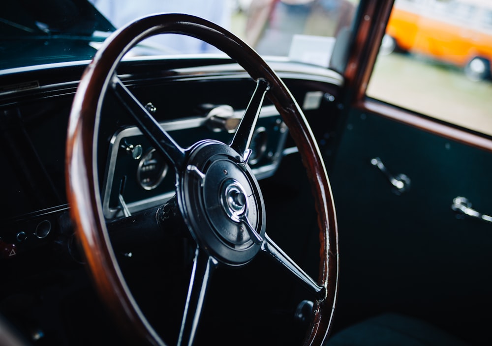 closed up photo of brown and black vehicle steering wheel