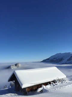Snow-covered peaks visible from the cabin’s large windows.