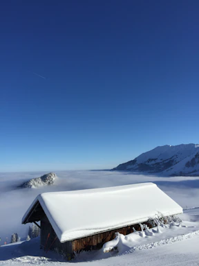 Snow-covered peaks visible from the cabin’s large windows.