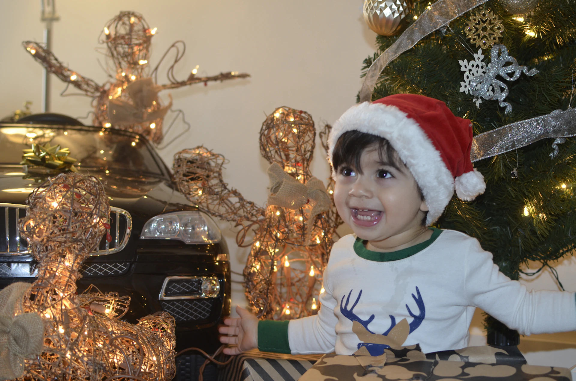 A joyful child playing with a vibrant toy set, surrounded by gift boxes wrapped in shiny paper, highlighting the festive sale.