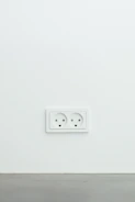 Electrician installing a new wall outlet in a cozy home