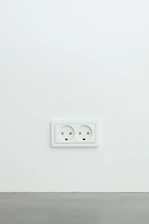 Electrician installing a new wall outlet in a cozy home