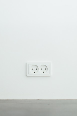 A sleek Legrand socket outlet mounted on a white wall with elegant design.