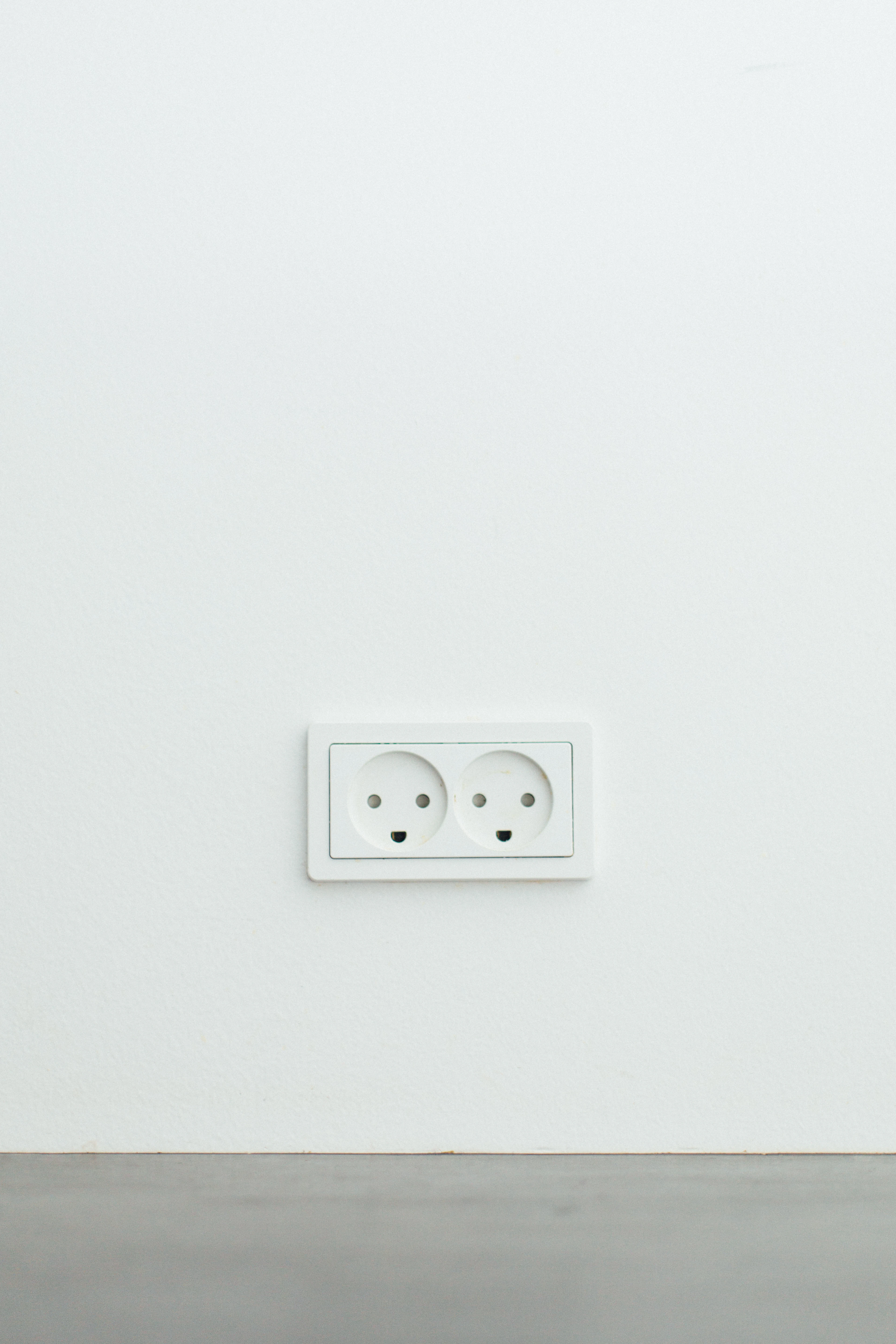 White three-pin wall socket in a Dubai home