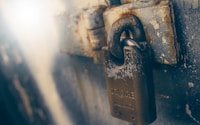 brown padlock in black wooden door