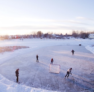 group of people playing outdoor hockey during winter