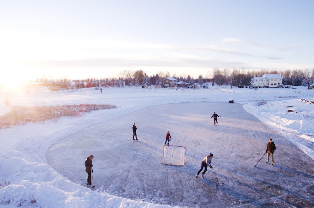 group of people playing outdoor hockey during winter