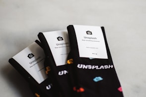 three pairs of black Unflash socks