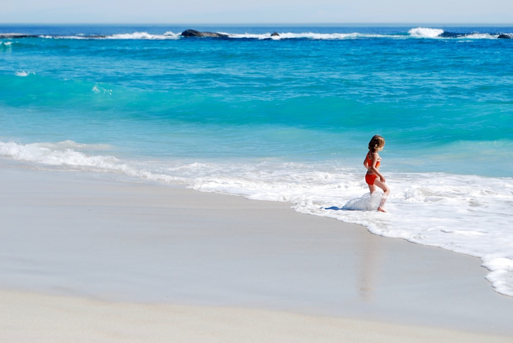 woman running towards shore