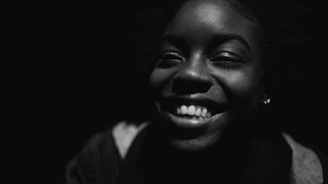Close-up photo of a smiling team leader with a professional background.