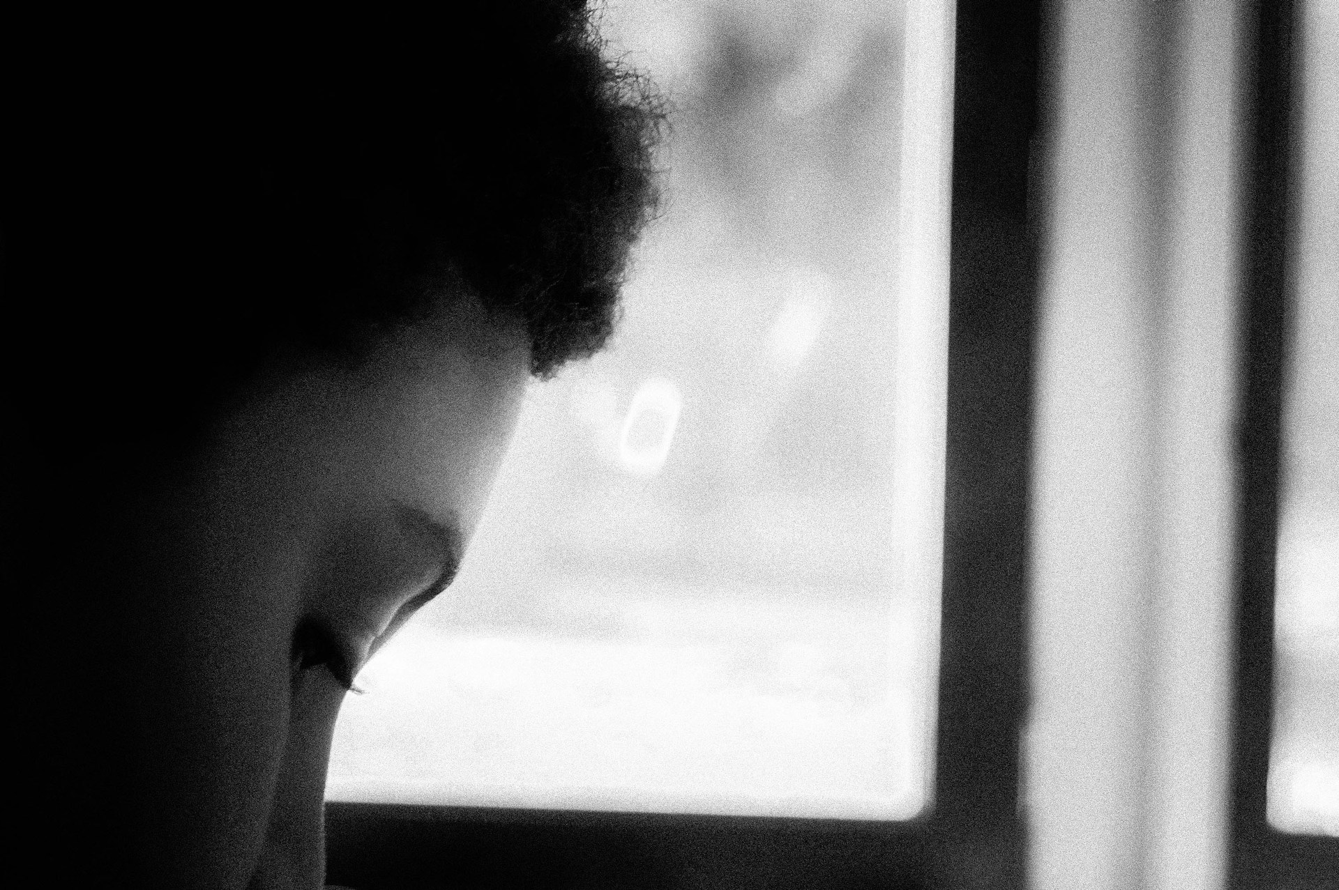 A serene black-and-white photograph capturing a quiet moment of inspiration in the artist's studio.