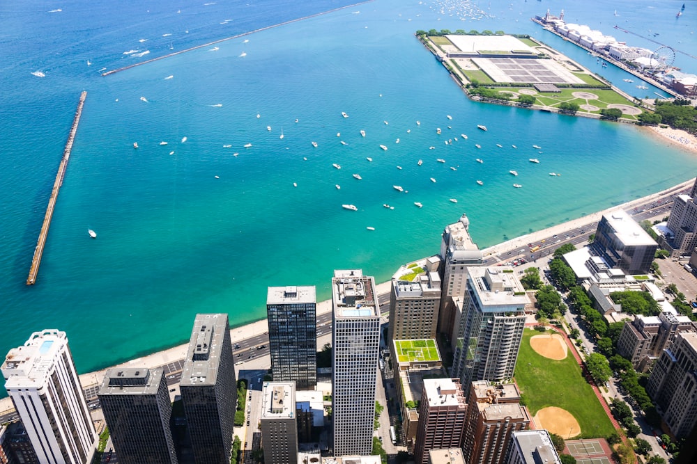 aerial photo of cityscape beside teal calm body of water at daytime