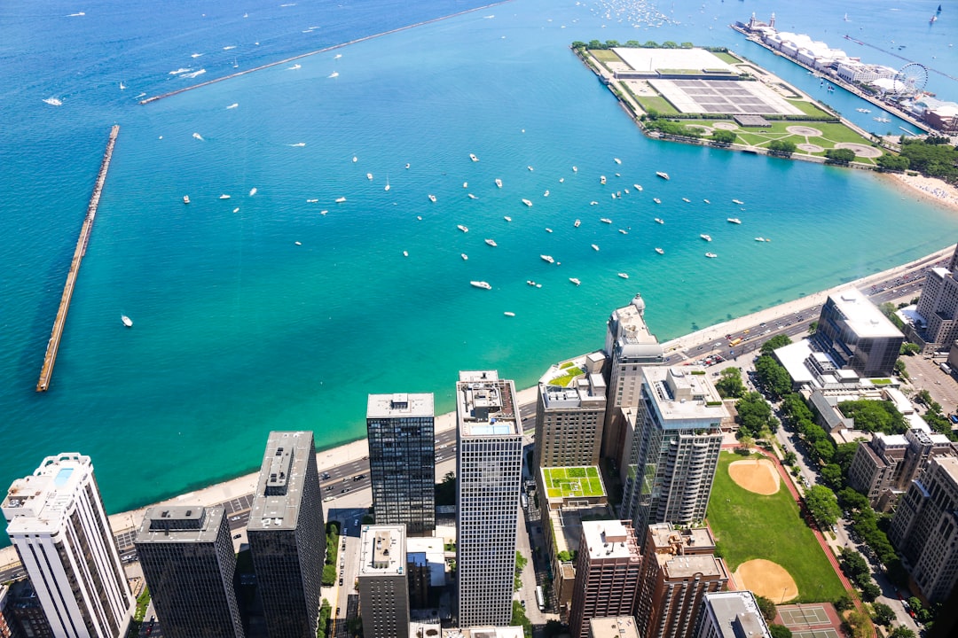 aerial photo of cityscape beside teal calm body of water at daytime,