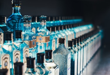 depth with layering for photo composition,how to photograph bombay sapphire distillery; shallow focus photography of bottles