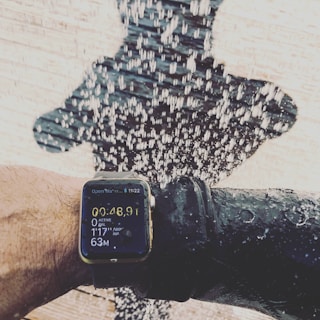 Coach and athlete reviewing performance metrics on a tablet poolside.