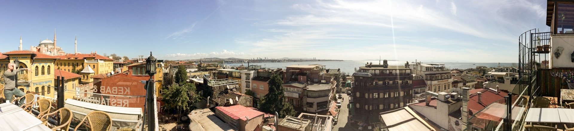 A panoramic view capturing elements of Pakistan's economic investment scene, including crypto and stocks charts on screens, real estate development sites, and strategic discussions around Vision 2030 initiatives with business management teams.