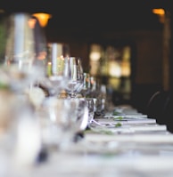 focused photo of wine glasses lined on table