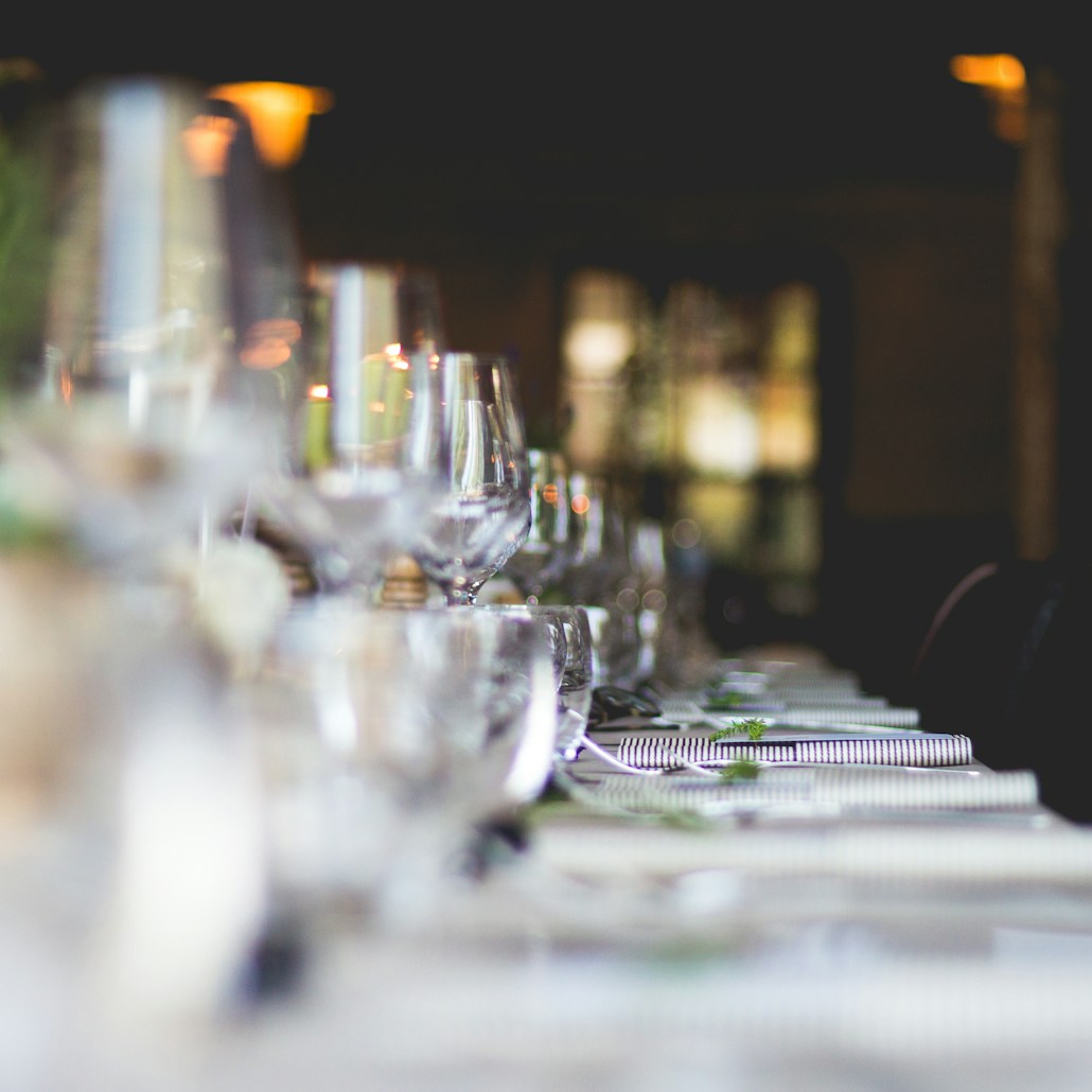 focused photo of wine glasses lined on table