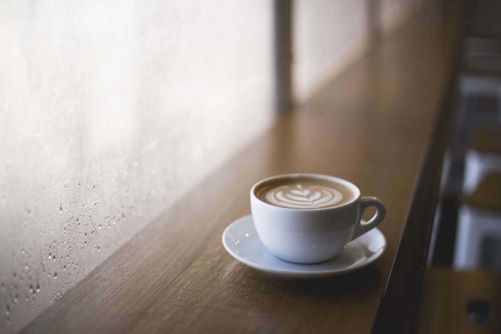 brown liquid on white ceramic cup and saucer