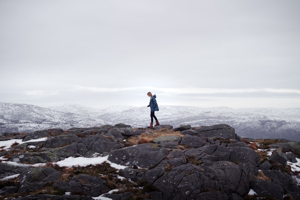 man standing on mountain during daytime