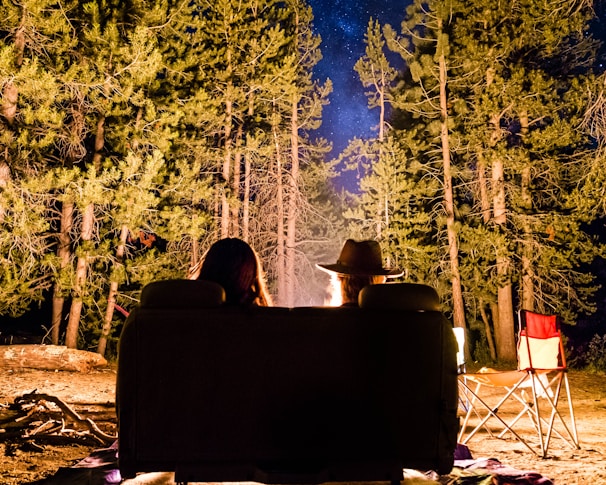 man and woman in front of campfire