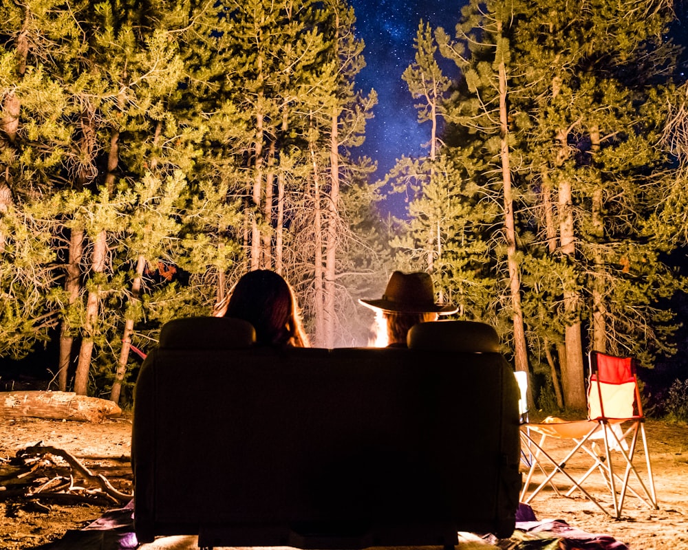 man and woman in front of campfire