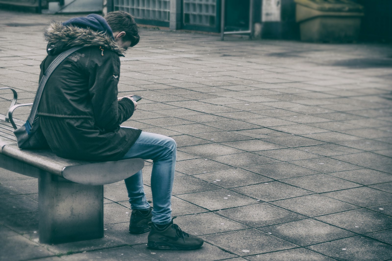 Sigma 18-50mm f/2.8 Macro sample photo. Man sitting on bench photography