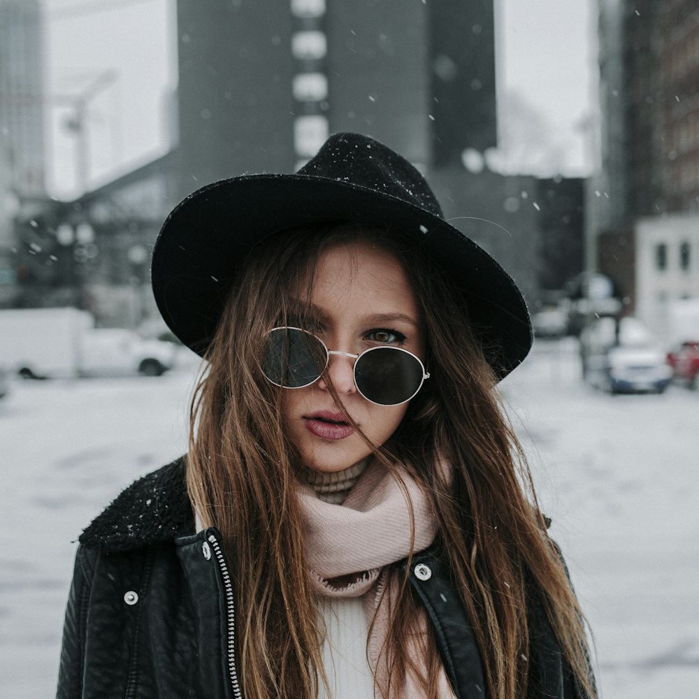 shallow focus photography of woman wearing hat while snowing